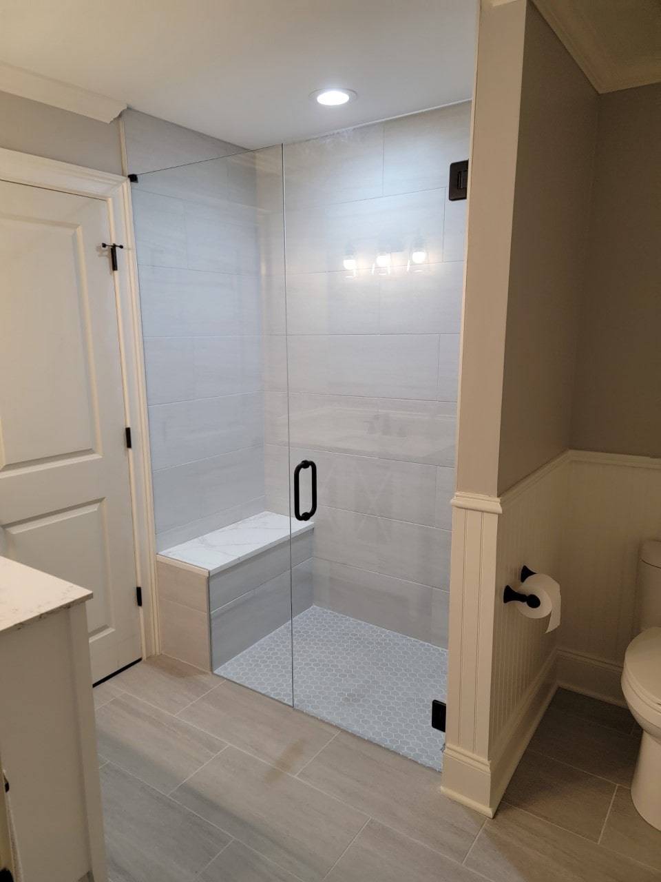 Well Lighted Shower Room With Glass Doors