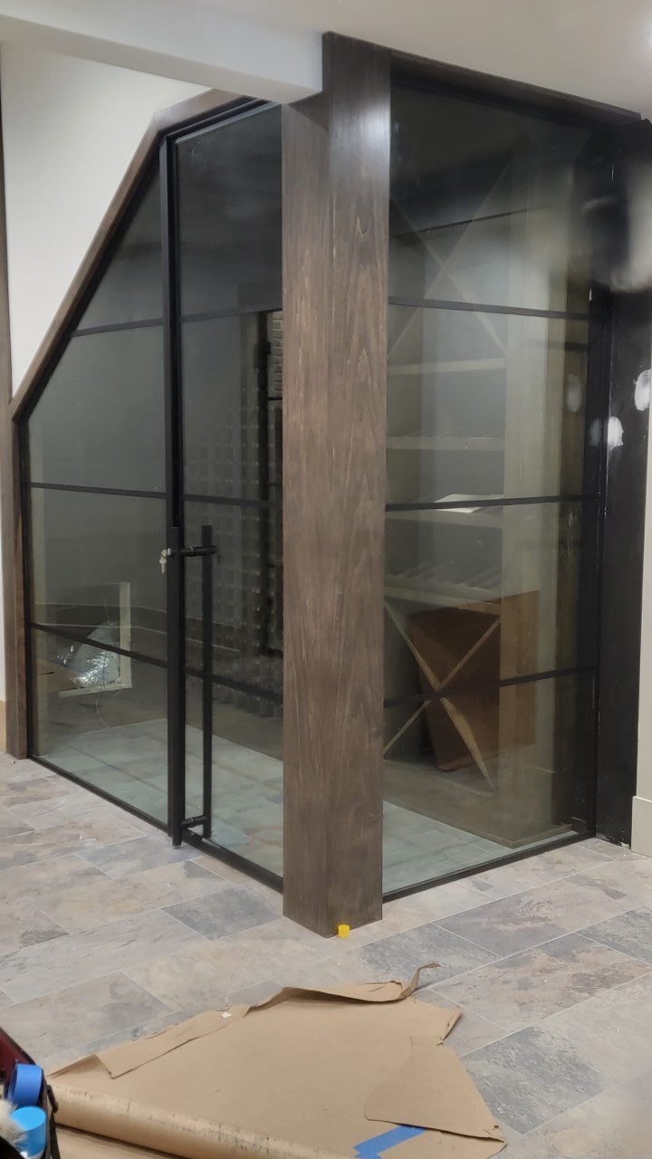 Wine Cellar With Framed Glass Walls And Doors